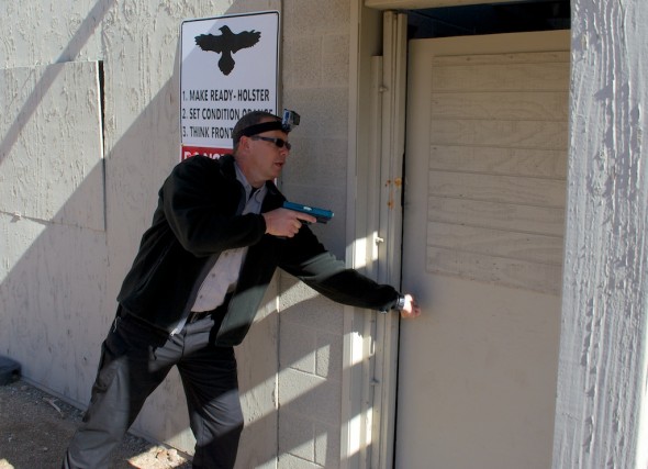 Step 1 of the house clearing exercise - opening the door. The Glock is equipped with a Simunitions conversion and the new LaserMax Native Green laser.